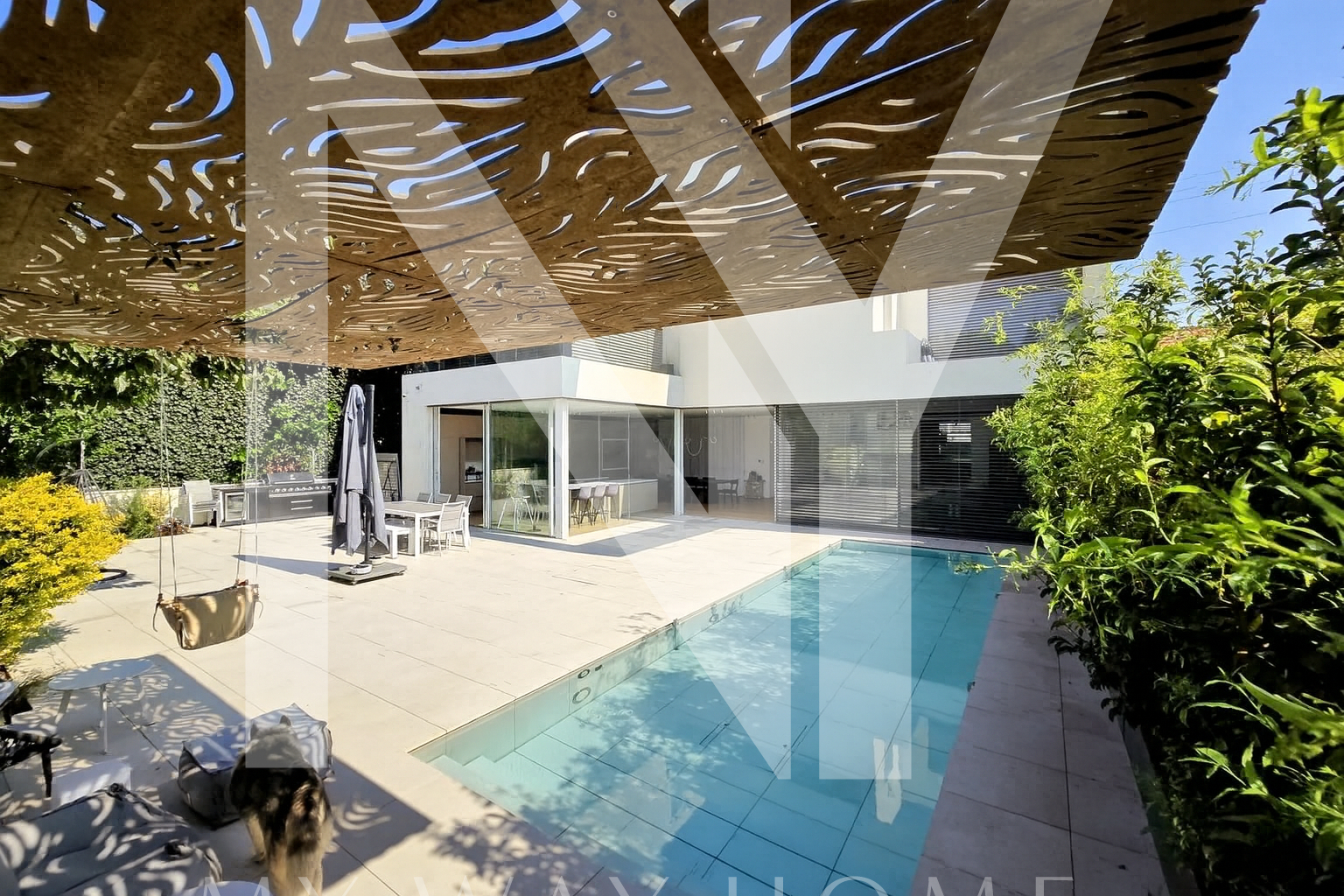Private swimming pool with landscaped garden in a modern South Ra’anana villa